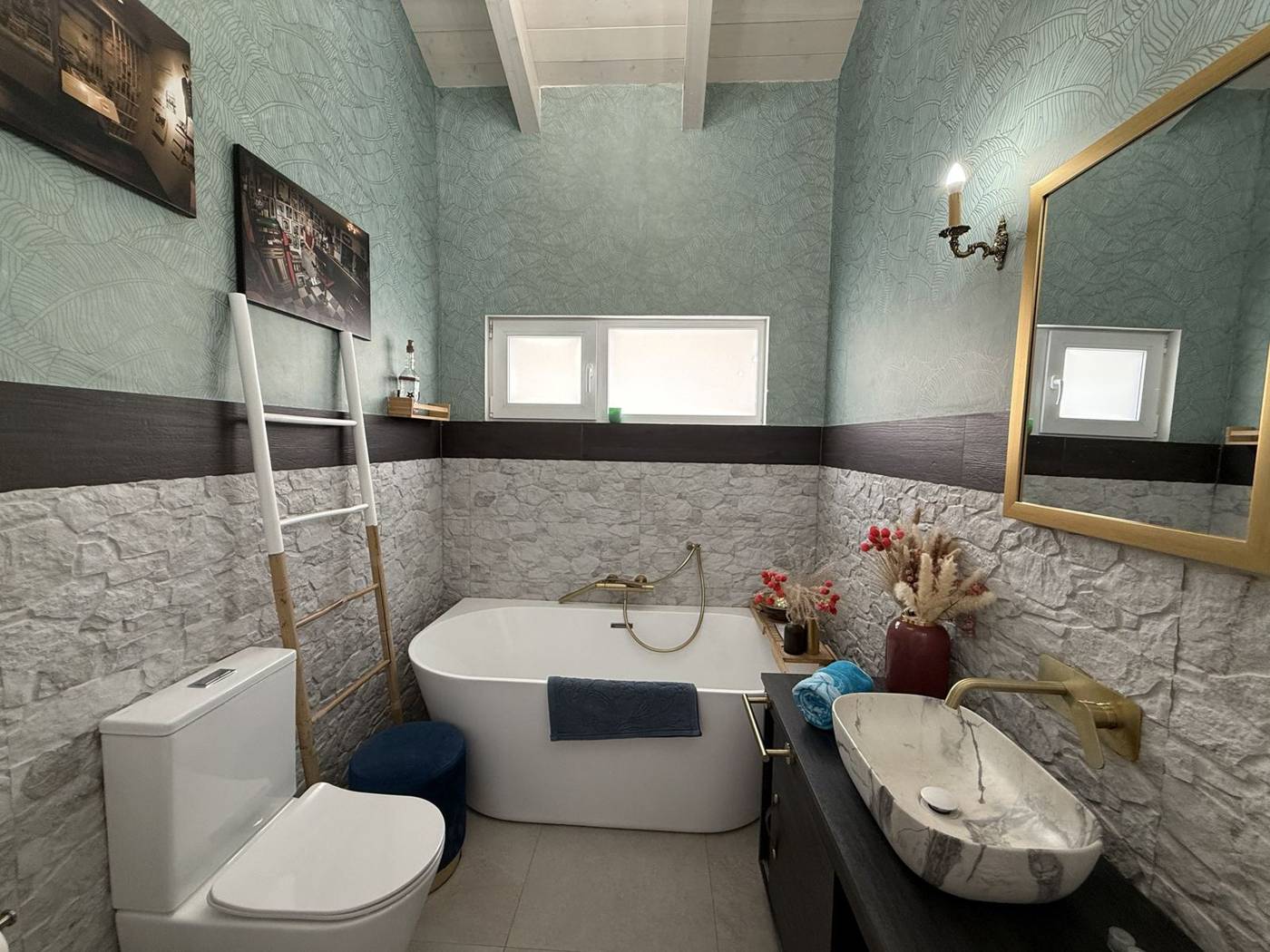 Baño con bañera exenta y lavabo de mármol